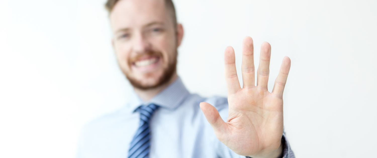 Close up of business man with five fingers held up