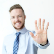 Close up of business man with five fingers held up